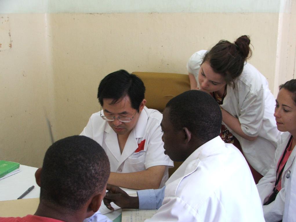 2011年7月22日，在坦桑尼亞桑給巴爾納茲莫加醫院外科門診，中國第24批援桑給巴爾醫療隊隊長盧建林為當地患者診治并帶教實習生。新華社發（國家衛生健康委供圖）