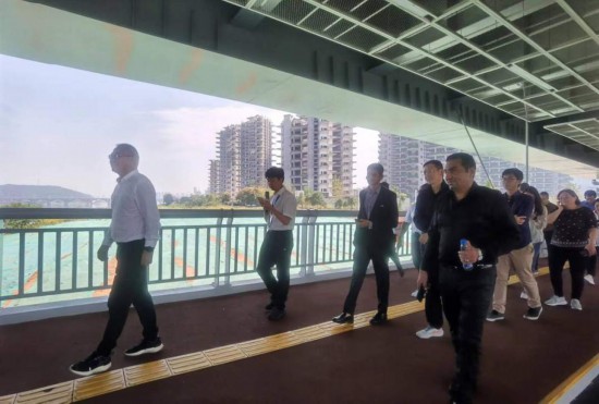 　　10月24日，2023“一帶一路”媒體合作論壇聯合采訪團團員走在清水塘大橋景觀通道上。本報記者 常雯宜攝