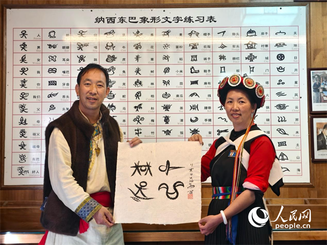 人民網(wǎng)“行進(jìn)中國”云南調(diào)研采訪團(tuán)走進(jìn)麗江，和閏元現(xiàn)場用東巴文寫下“行進(jìn)中國”。人民網(wǎng)記者 符皓攝