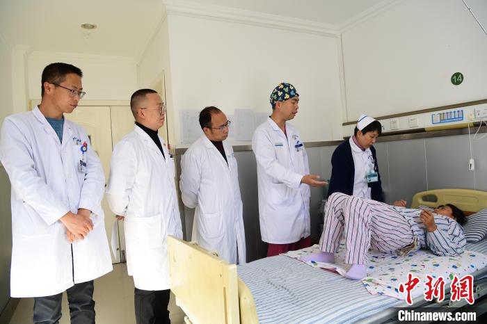 圖為何蔚副主任醫(yī)師(站右二)及團隊術后指導患者進行腰背肌鍛煉。　貢嘎來松 攝